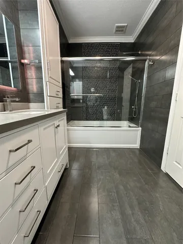 a bathroom with a granite countertop toilet sink and mirror