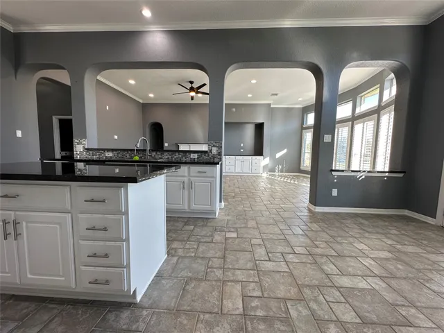 a large kitchen with stainless steel appliances and a stove top oven