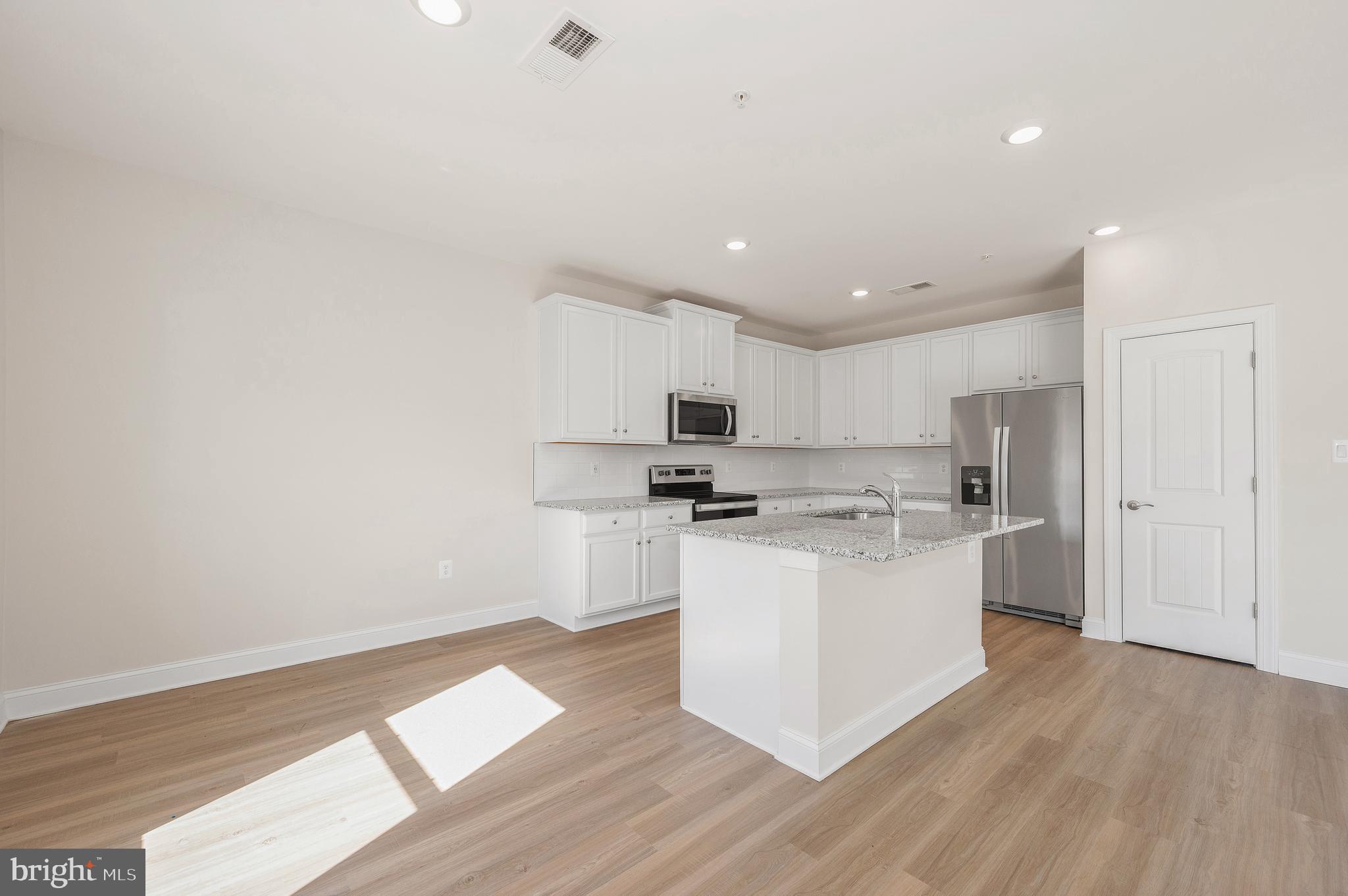 9962 Roulette Drive Hagerstown, MD 21740 - Photo 11 of 43 a kitchen with a sink a stove top oven and white kitchen