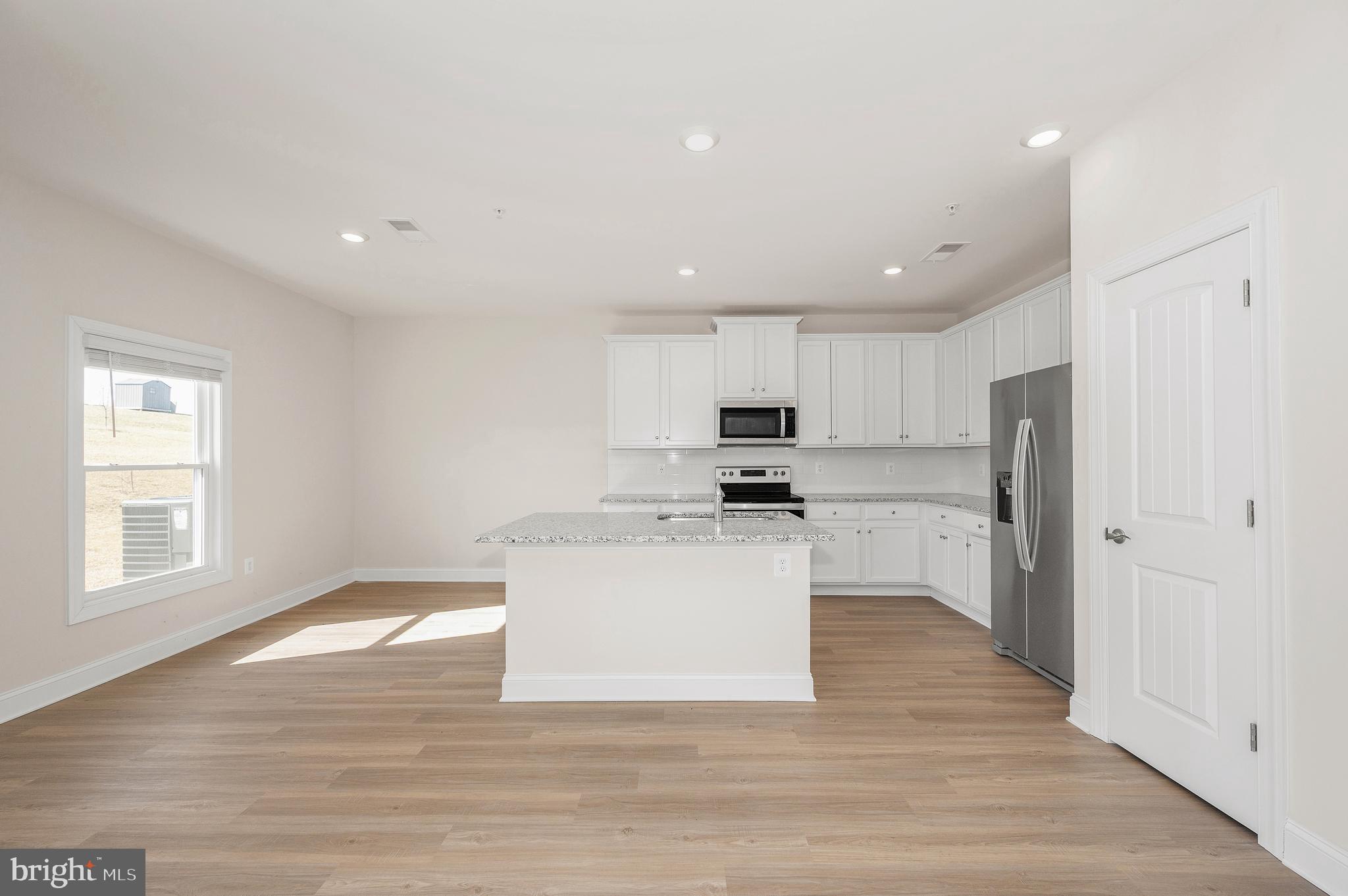 9962 Roulette Drive Hagerstown, MD 21740 - Photo 12 of 43 a view of kitchen with microwave oven a refrigerator and white cabinets
