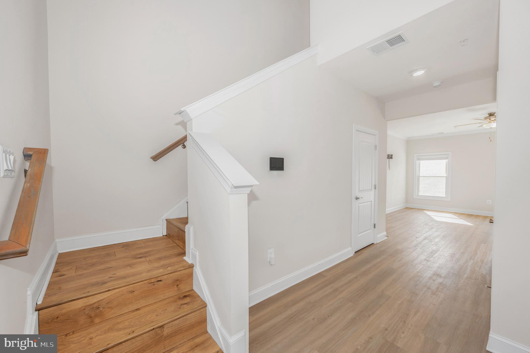9962 Roulette Drive Hagerstown, MD 21740 - Photo 18 of 43 a view of a hallway with wooden floor and staircase