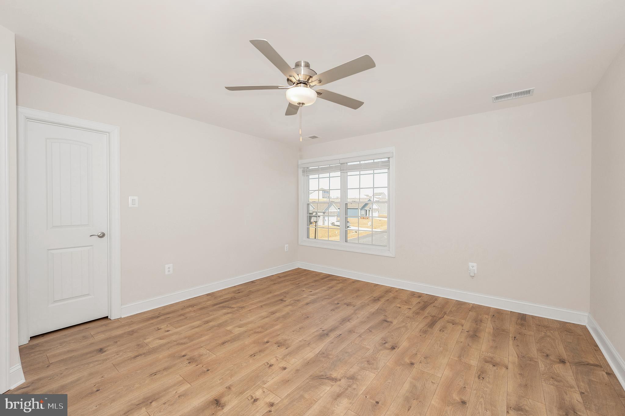 9962 Roulette Drive Hagerstown, MD 21740 - Photo 21 of 43 a view of empty room with wooden floor and ceiling fan