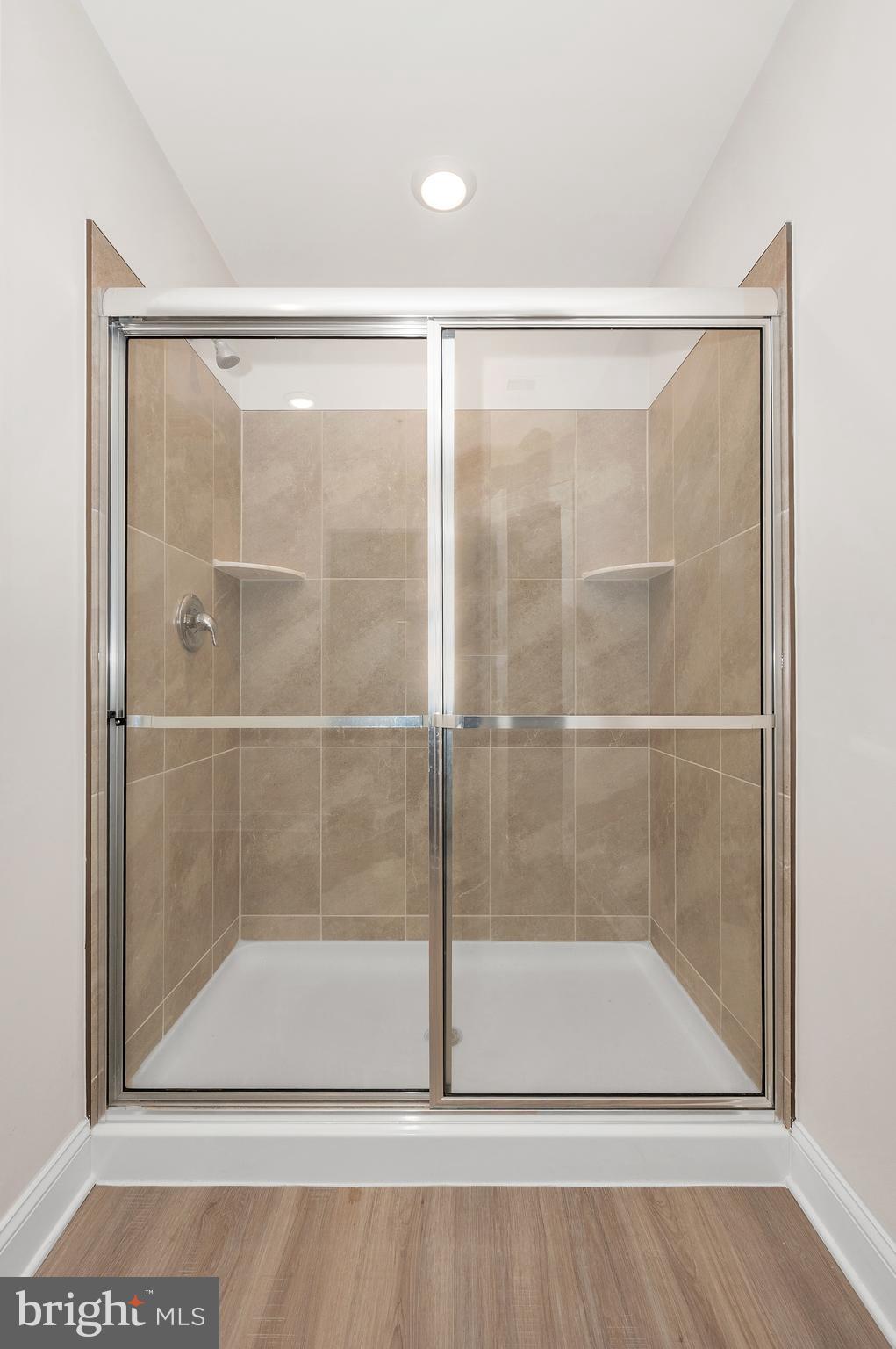 9962 Roulette Drive Hagerstown, MD 21740 - Photo 26 of 43 a bathroom with a glass shower door