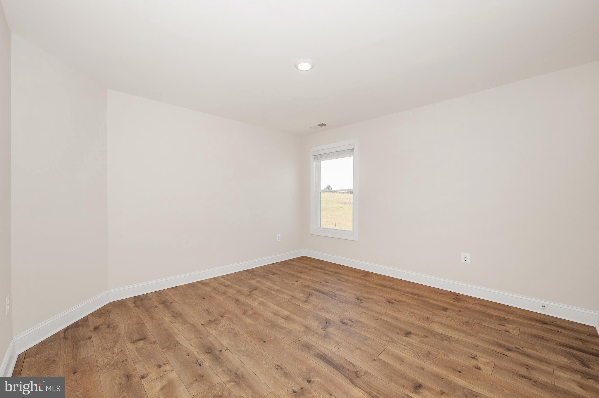 9962 Roulette Drive Hagerstown, MD 21740 - Photo 28 of 43 an empty room with wooden floor and windows