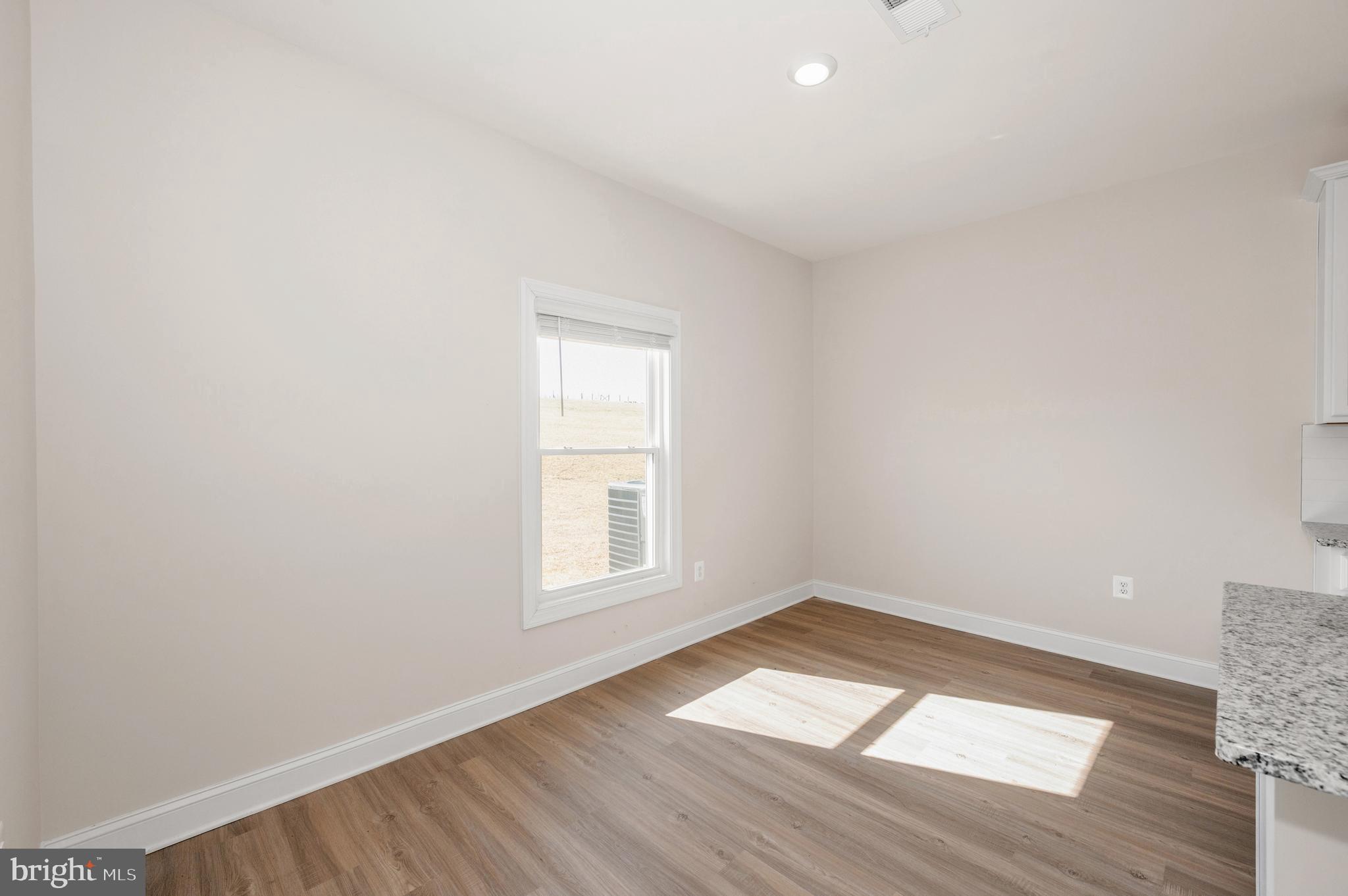 9962 Roulette Drive Hagerstown, MD 21740 - Photo 9 of 43 an empty room with wooden floor and windows