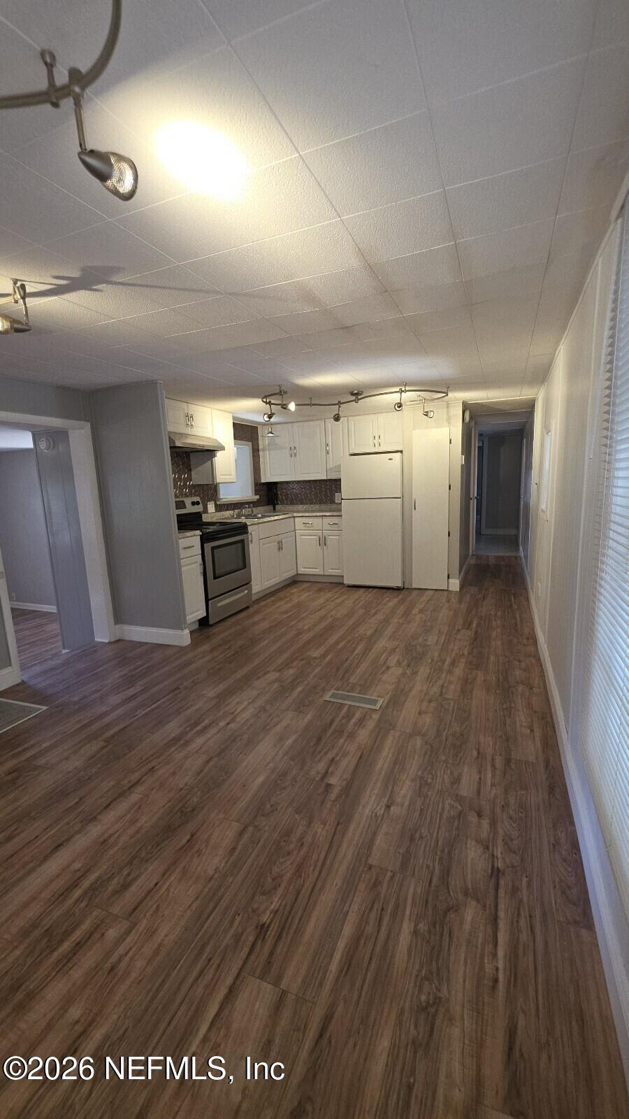 2781 Schaller Road St. Augustine, FL 32084 - Photo 6 of 9 a view of a kitchen with furniture and wooden floor