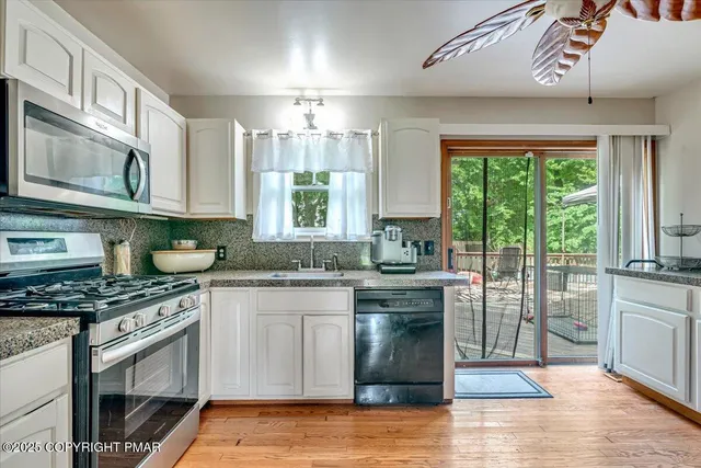 a view of a livingroom with furniture and a kitchen view
