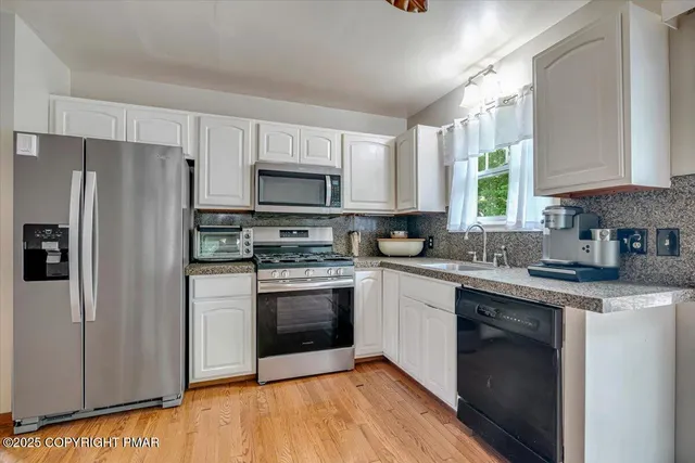 a bathroom with a granite countertop toilet a sink and a mirror