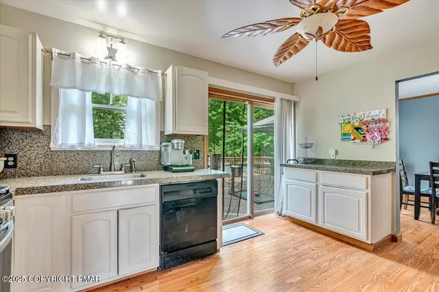a bedroom with a bed window chair and flat screen tv