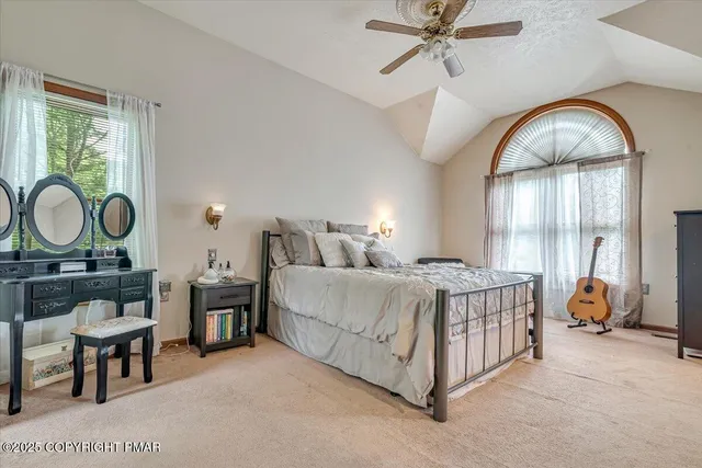 a bathroom with a granite countertop toilet sink and mirror