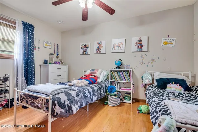 a living room with furniture a flat screen tv and a floor to ceiling window