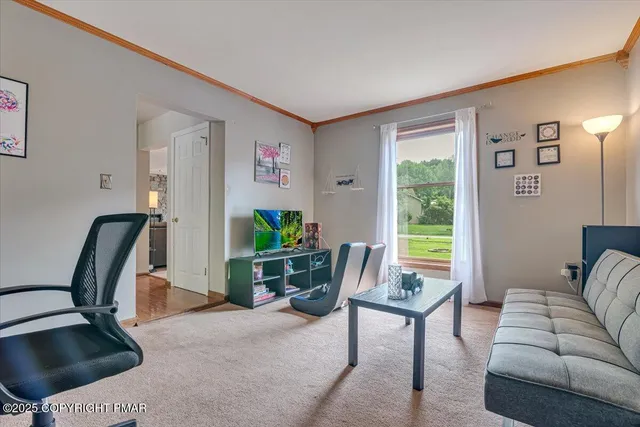 a view of a house with a deck and a yard