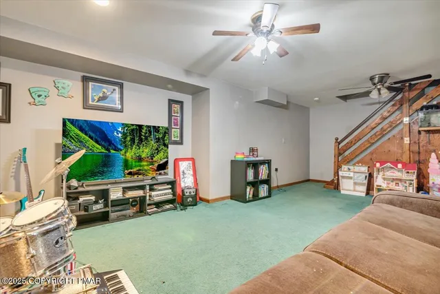 an aerial view of residential houses with outdoor space and trees