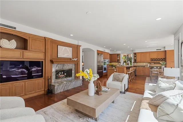 a kitchen with stainless steel appliances granite countertop a stove and a view of living room