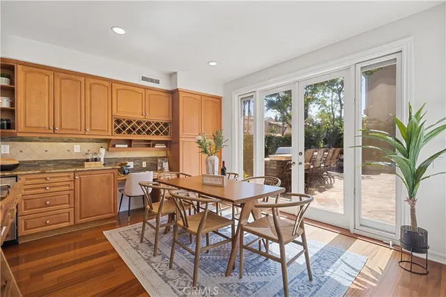 a view of a patio with couches table and chairs and potted plants