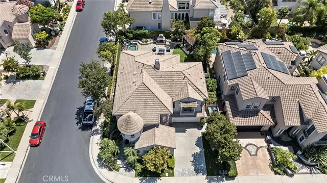an aerial view of a house with a yard and potted plants