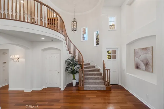 a view of entryway and hall with wooden floor