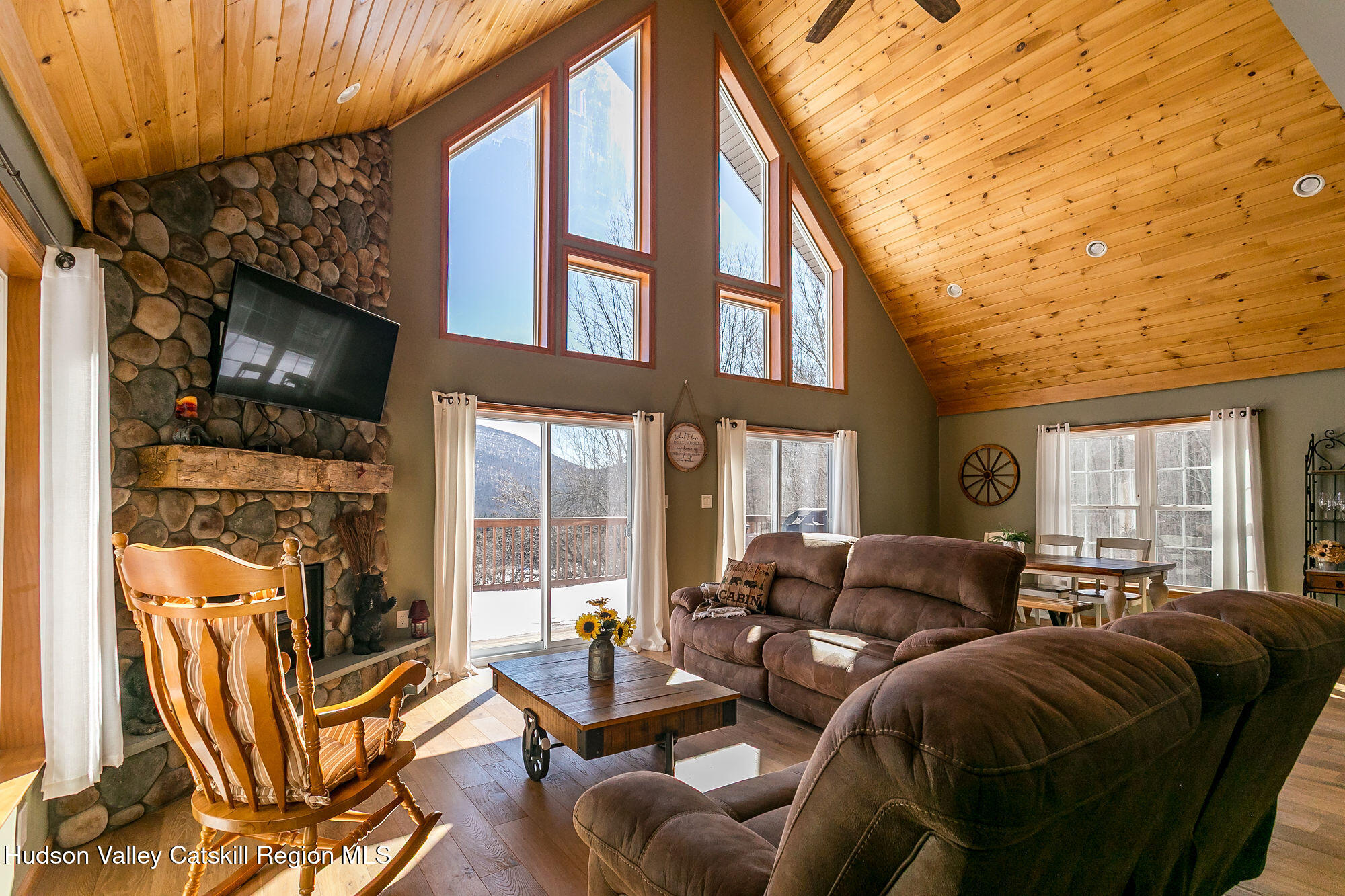 295 Tumbleweed Ranch Road West Kill, NY 12492 - Photo 6 of 49 a living room with furniture a flat screen tv and floor to ceiling window