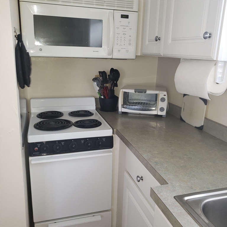 398 North End, Unit B Salisbury, MA 01952 - Photo 6 of 13 a kitchen with a sink and cabinets