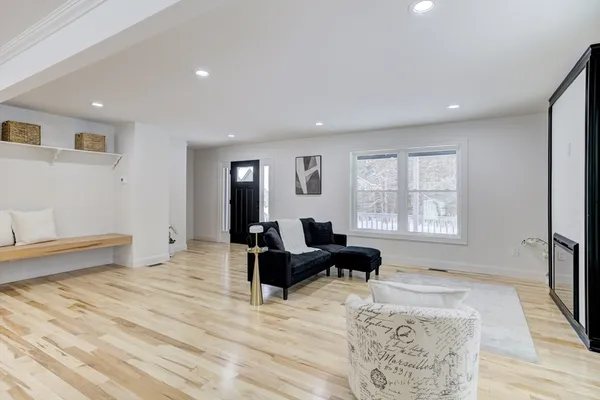 a living room with furniture window and a wooden floor