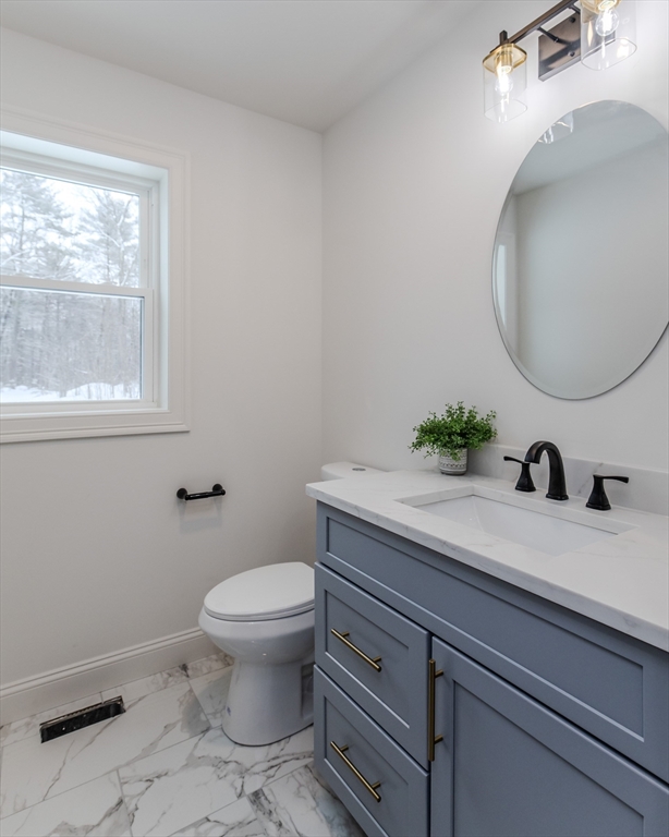 6 Winslow Road Ware, MA 01082 - Photo 13 of 34 a bathroom with a granite countertop toilet sink and mirror