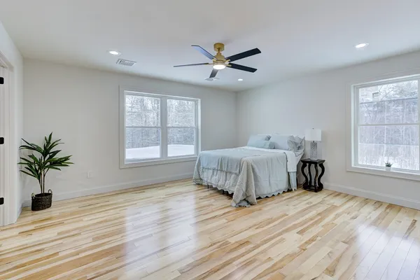 a bedroom with a bed and a window