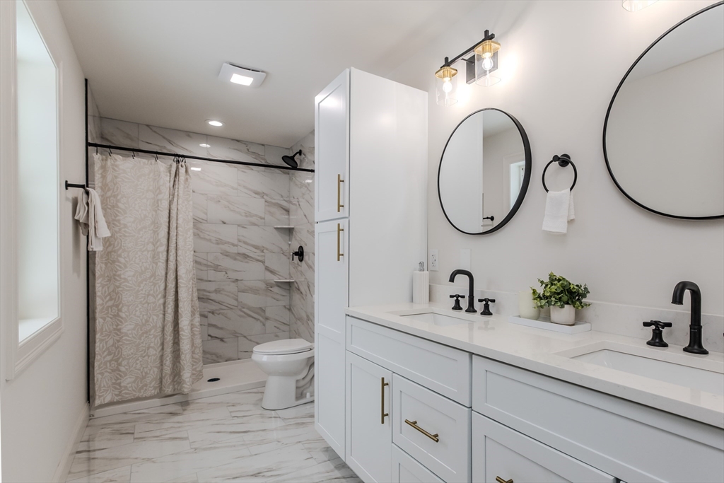 6 Winslow Road Ware, MA 01082 - Photo 20 of 34 a bathroom with a granite countertop sink a toilet and a mirror