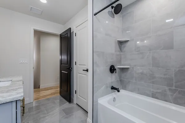 a bathroom with a bathtub and a shower