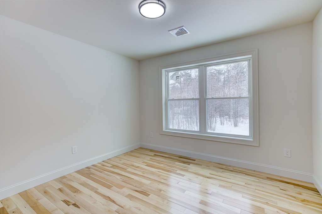 6 Winslow Road Ware, MA 01082 - Photo 29 of 34 an empty room with wooden floor and windows