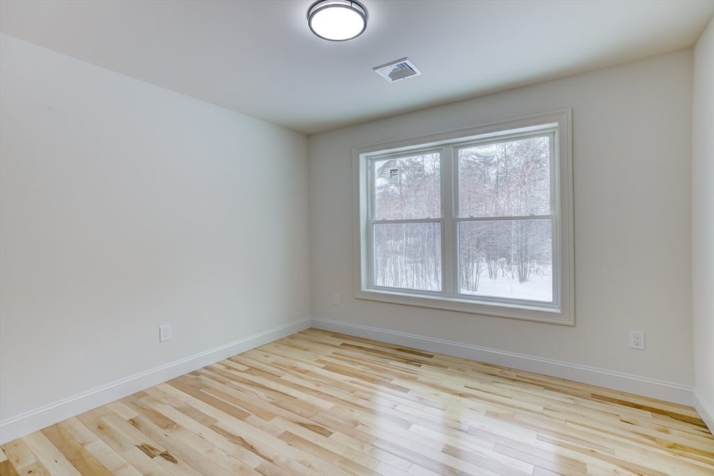6 Winslow Road Ware, MA 01082 - Photo 30 of 35 an empty room with wooden floor and windows