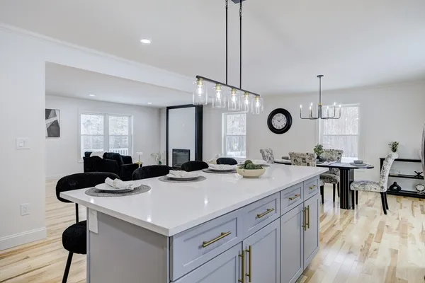 a kitchen with a sink a cabinets and chairs