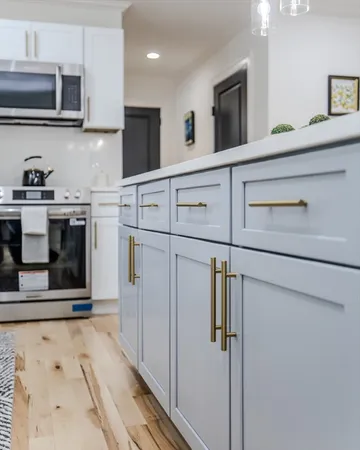a kitchen with stainless steel appliances granite countertop a refrigerator and a stove top oven