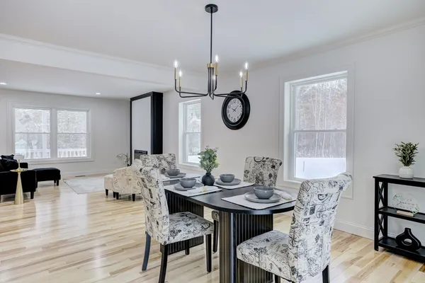 a view of a dining room with furniture window and wooden floor