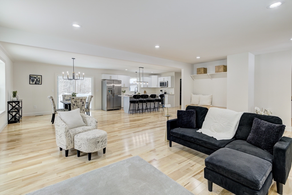 6 Winslow Road Ware, MA 01082 - Photo 10 of 34 a living room with furniture and a dining table with kitchen view