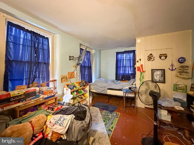 a room with furniture a rug and gym equipment