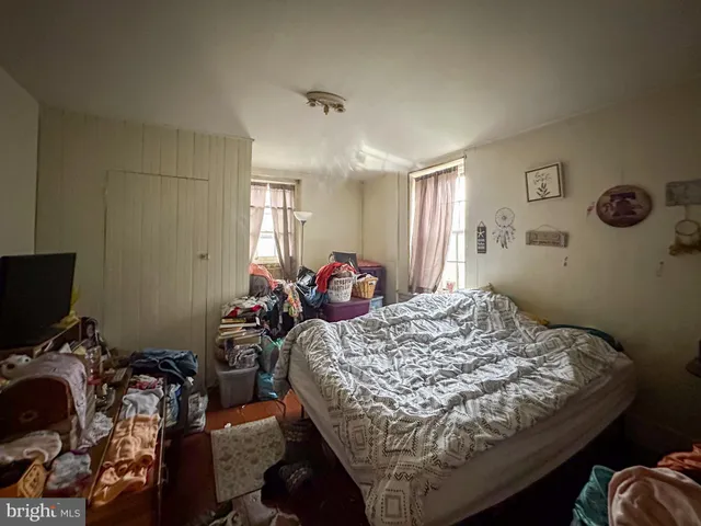 a bed room with a bed and a television