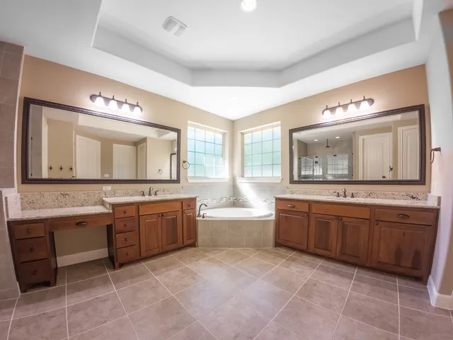 a large bathroom with a large tub and sink