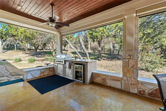 a large white kitchen with a large window