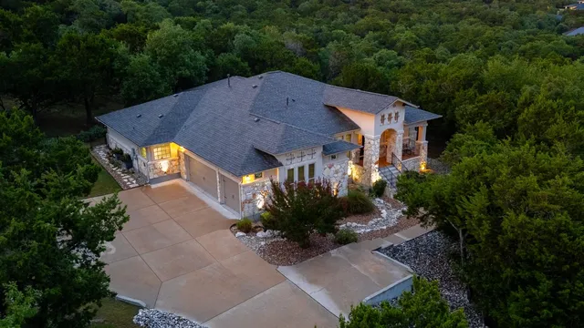 an aerial view of a house with a yard