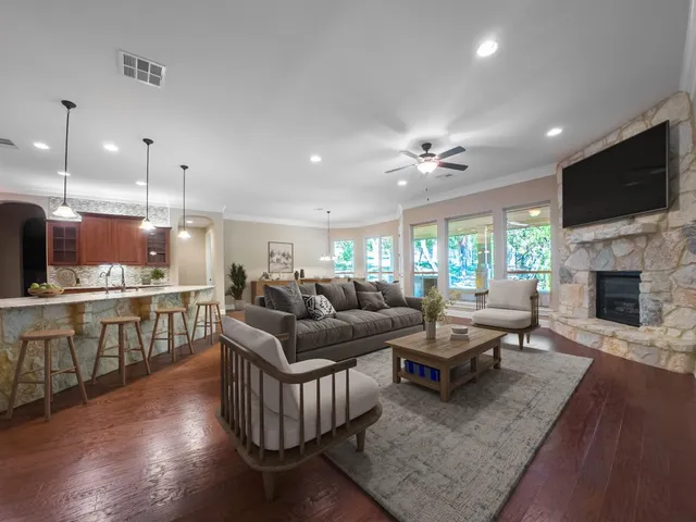 a living room with furniture fireplace and flat screen tv