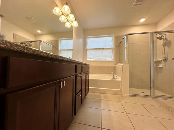a bathroom with a glass shower door and a shower