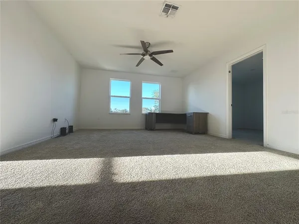 a view of a windows and a chandelier fan in the room