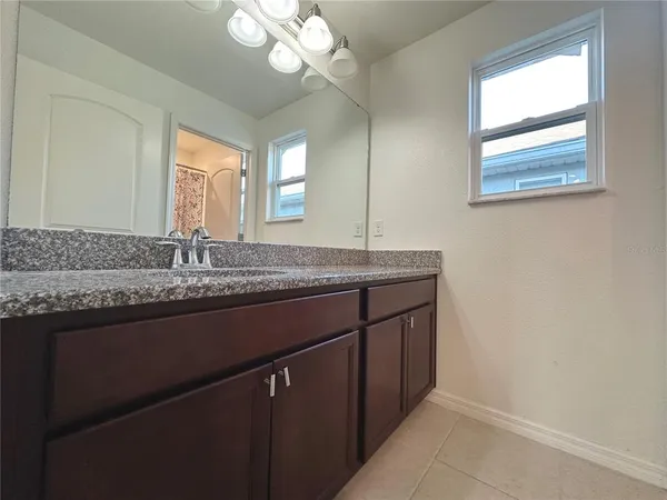 a bathroom with a sink a vanity and a mirror
