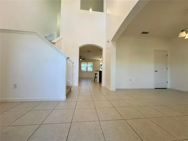 a view of a livingroom with an empty space and a stove top oven