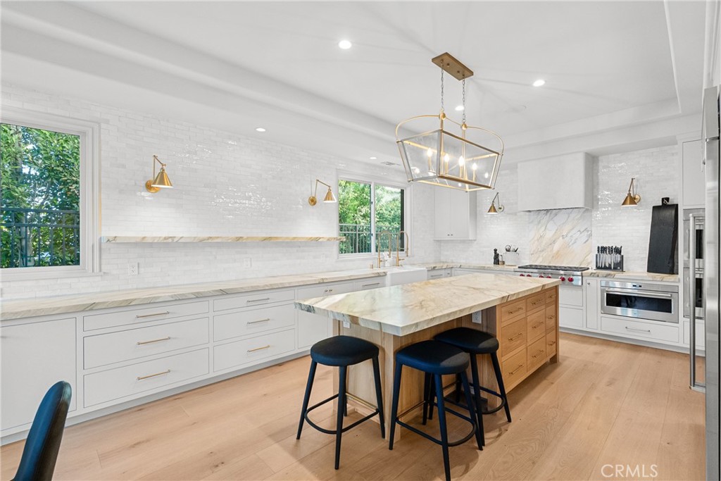 23477 Park Colombo Calabasas, CA 91302 - Photo 16 of 56 a kitchen with a table and chairs in it
