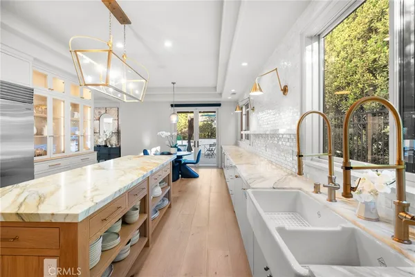 a bathroom with a granite countertop sink and a large mirror