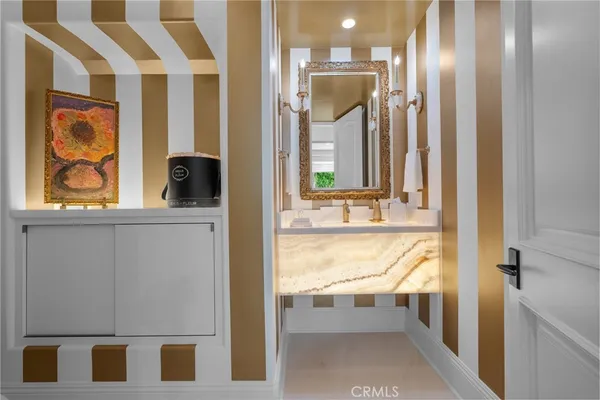 a bathroom with a sink a mirror and vanity