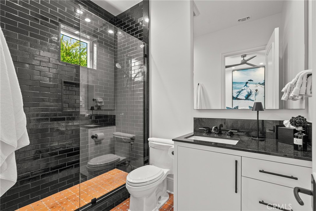 23477 Park Colombo Calabasas, CA 91302 - Photo 22 of 56 a bathroom with a toilet sink and mirror