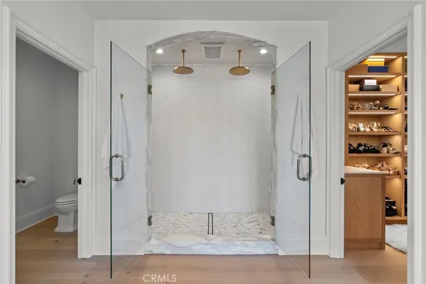 a bathroom with a sink toilet vanity and shower