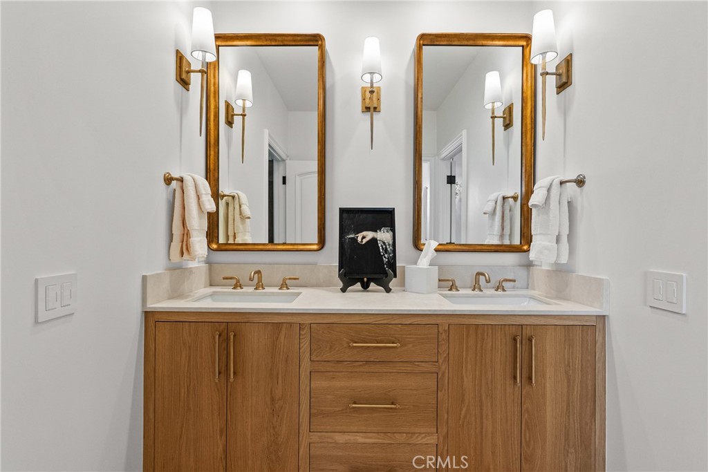 23477 Park Colombo Calabasas, CA 91302 - Photo 40 of 56 a bathroom with double vanity sinks and a mirror